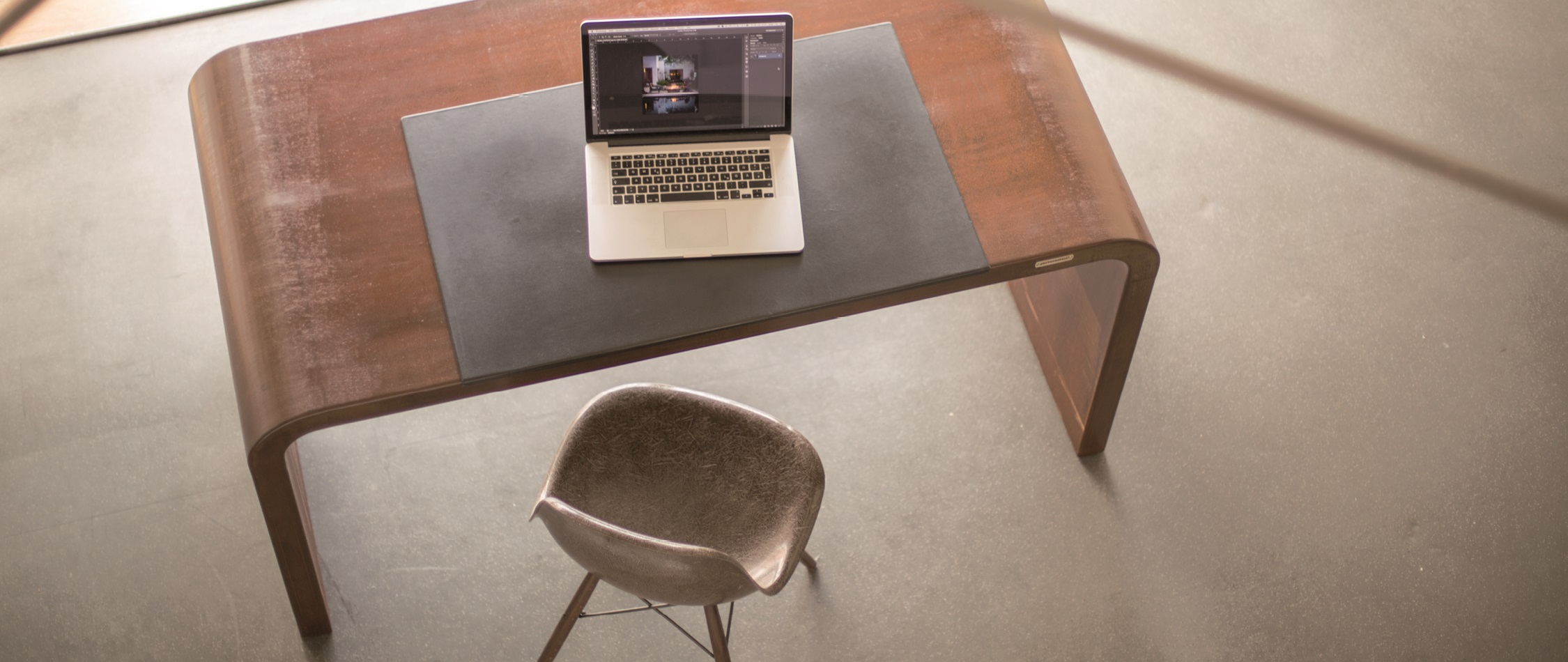 Designerschreibtisch aus gebogenem Cortenstahl mit justierbaren Füßen