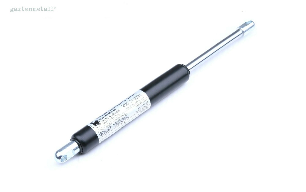 Gasdruckfeder, ausgefahren und liegend, vor weißem Hintergrund. Aufschrift: 'gartnermetall', 'WARNUNG: HOCHDRUCK', 'DONT OPEN' und Herstellerangaben auf dem Aufkleber.